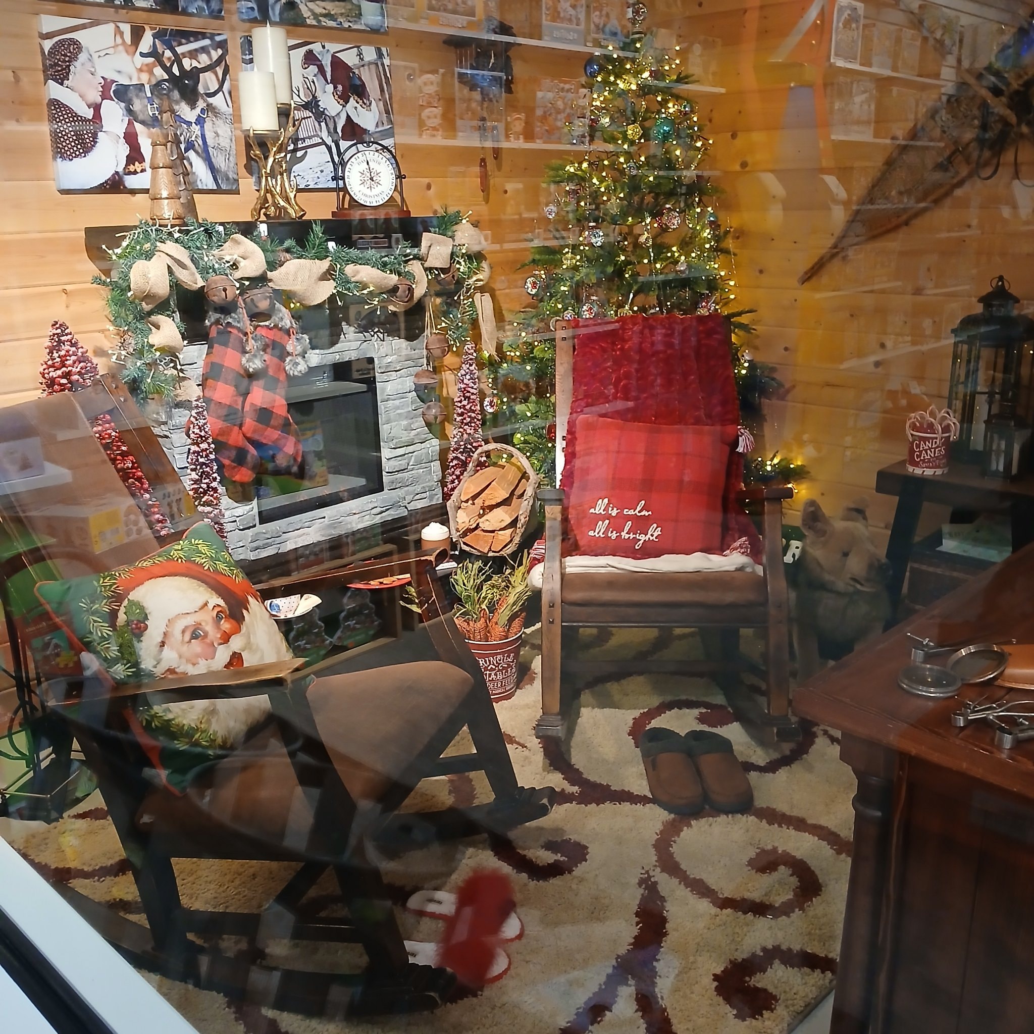 Santa's cabin interior with decorated fireplace and Christmas tree at North Pole, Alaska
