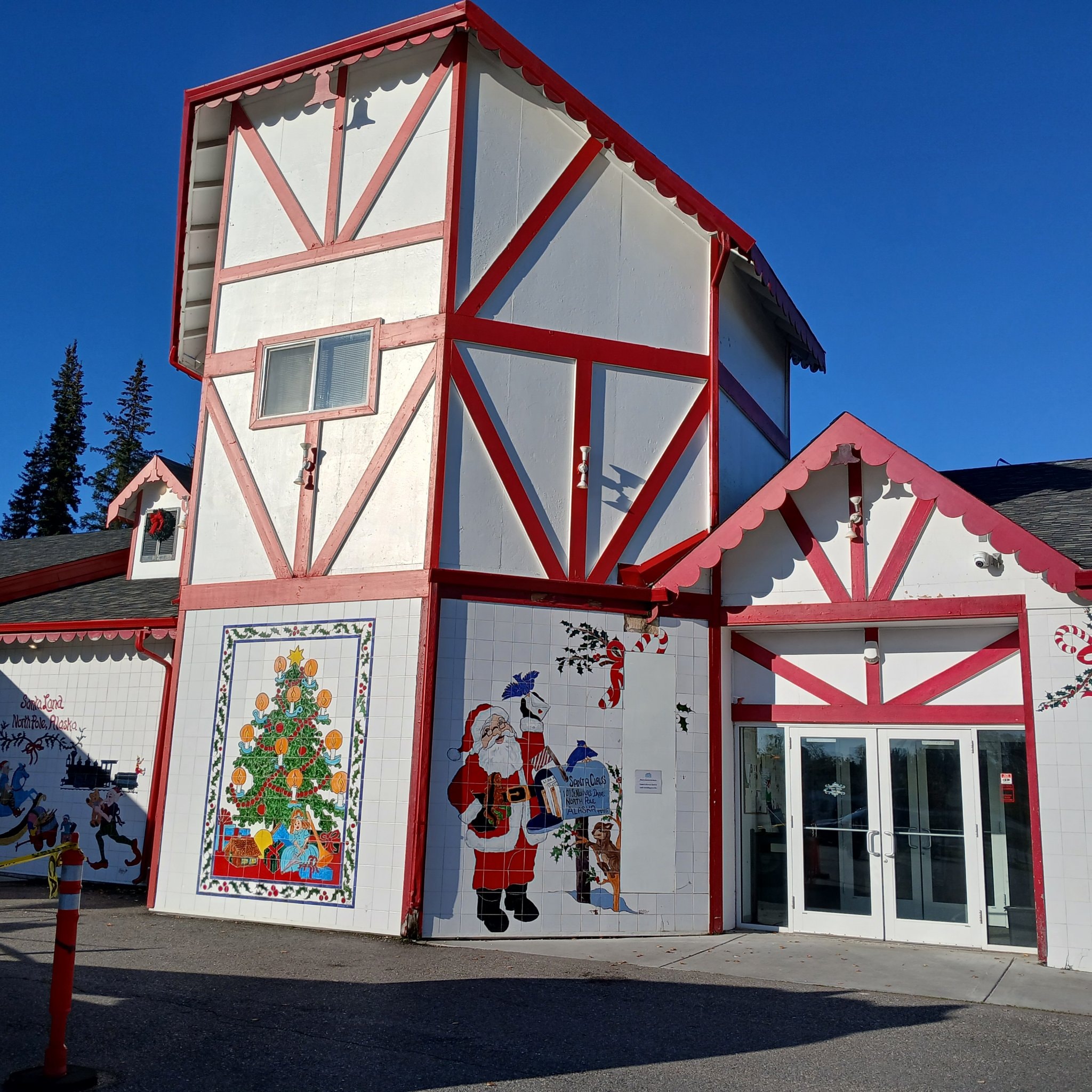Santa's House building exterior with Santa mural and red and white architecture at North Pole, Alaska