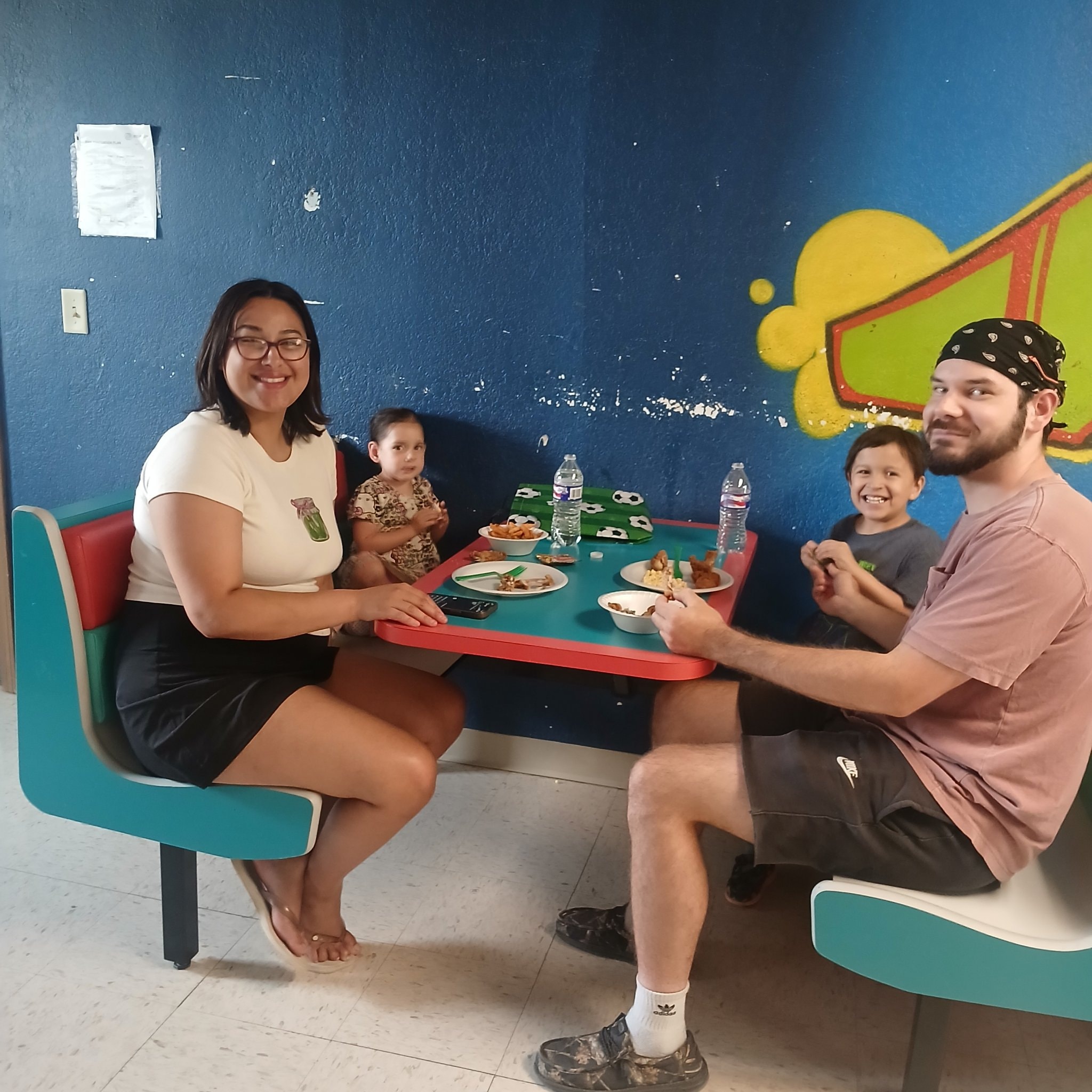 Family eating together at a table at the watch party